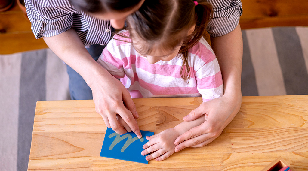 child learning how to write letters