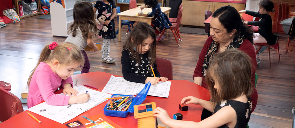 A teacher at a Montessori school in Austin leads a classroom lesson with children