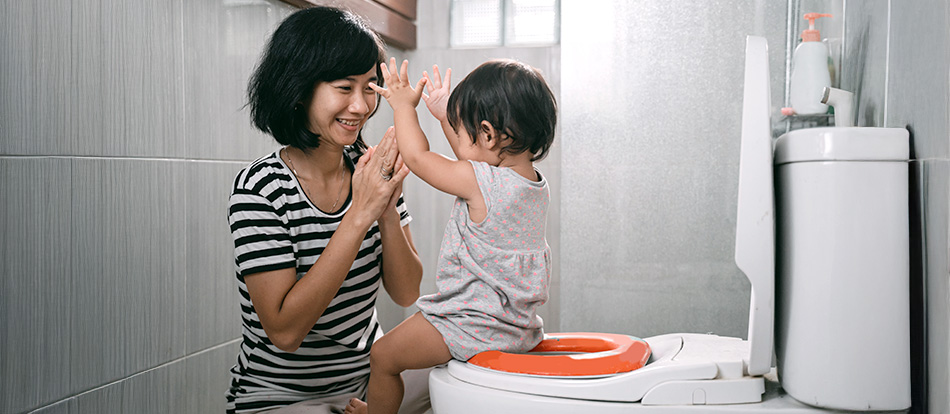 parent encourages their child during potty training