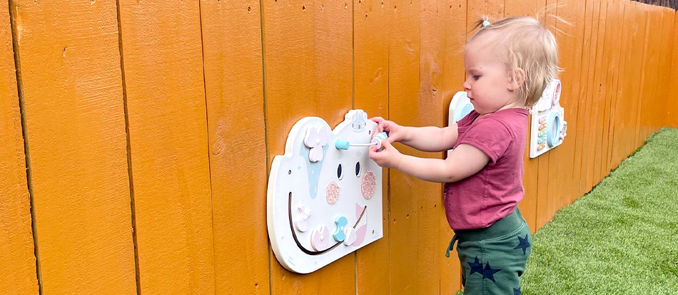young toddler plays outside during Montessori preschool