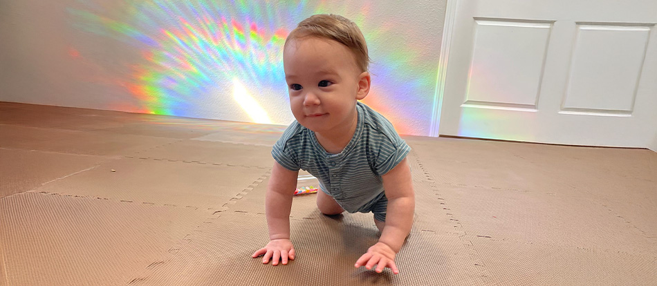 young toddler learning to crawl