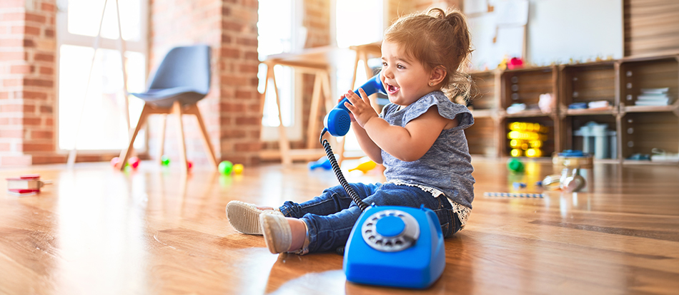 montessori preschool student plays out adult behavior like answering the phone
