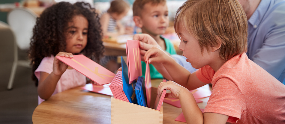 Montessori students learn the alphabet