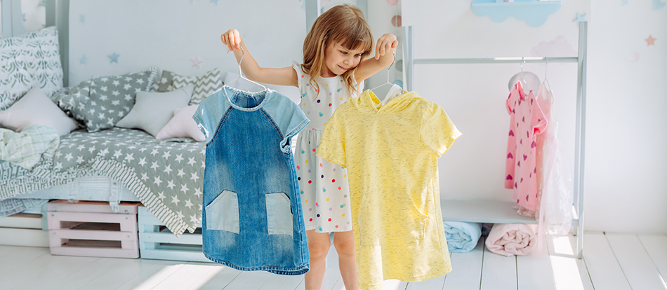 montessori toddler choosing her own clothes for the day