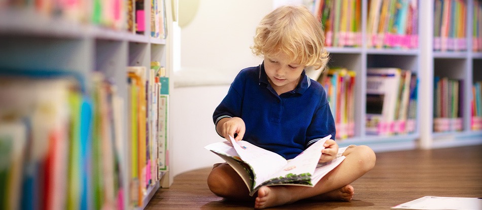 Montessori student learning to read independently